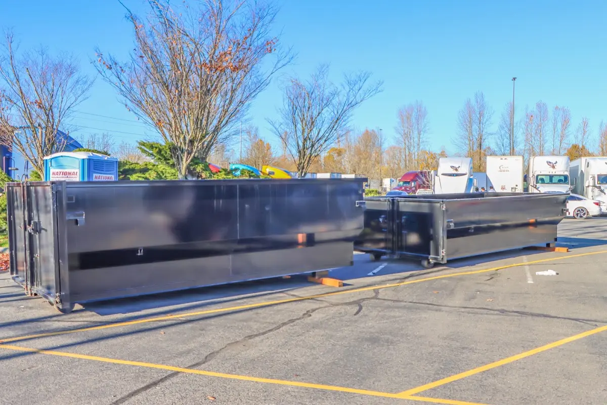 Professional dumpster rental service with roll-off container on residential driveway in Economy